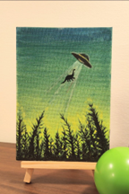 Canvas painting with scenery and a dinosaur been abducted by aliens. 