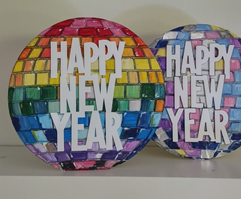 A circle painted in vibrant colors with Happy New Year letters in the center. 