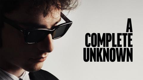 Timothy Chalamet as Bob Dylan in sunglasses with the words A Complete Unknown