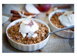 Baked apple slices in a dish with cool whip on top. 