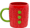 Red mug with a green handle and green buttons.