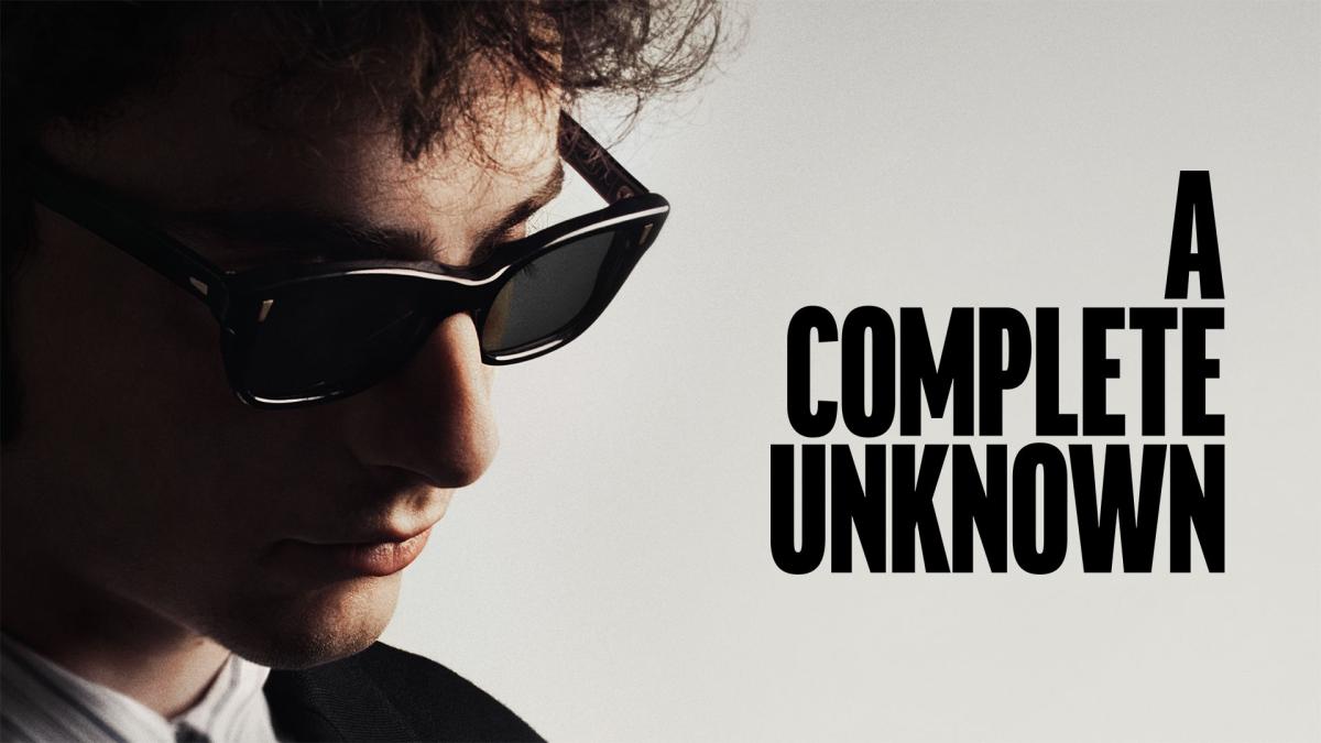 Timothy Chalamet as Bob Dylan in sunglasses with the words A Complete Unknown